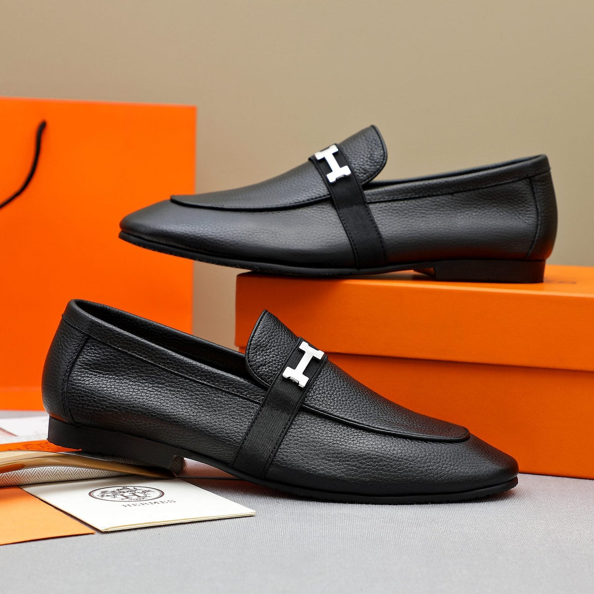 Hermès Black Pebbled Leather H-Hardware Loafers — front